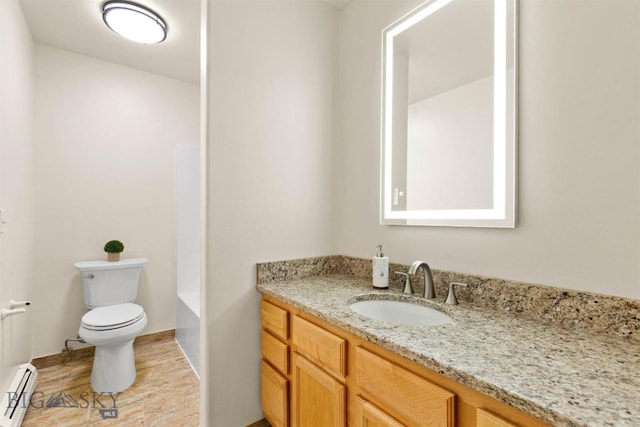 bathroom featuring vanity, a tub to relax in, a baseboard radiator, and toilet