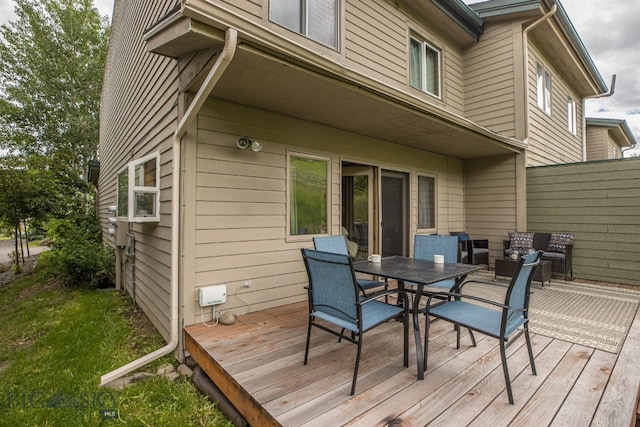 wooden terrace with an outdoor hangout area