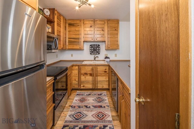 kitchen featuring light hardwood / wood-style floors, sink, and stainless steel appliances