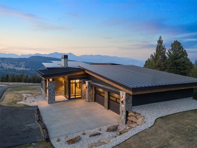 view of front of house with a mountain view and a garage