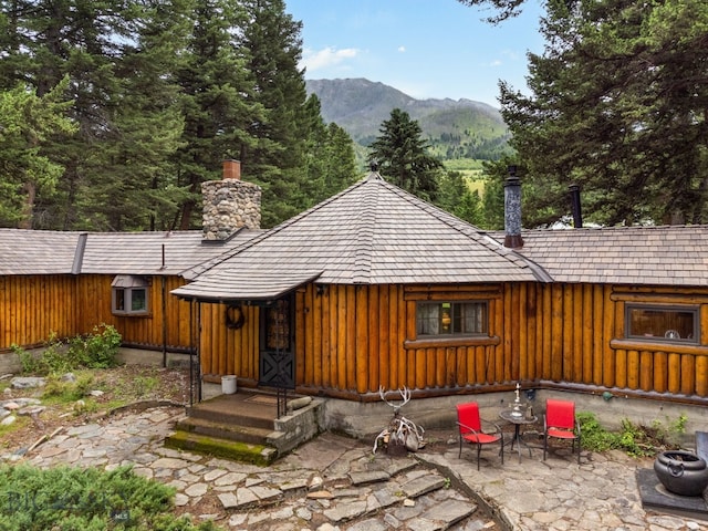 back of house with a mountain view and a patio area