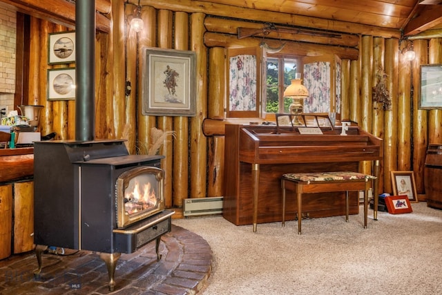 sitting room featuring baseboard heating, wood ceiling, a wood stove, and carpet