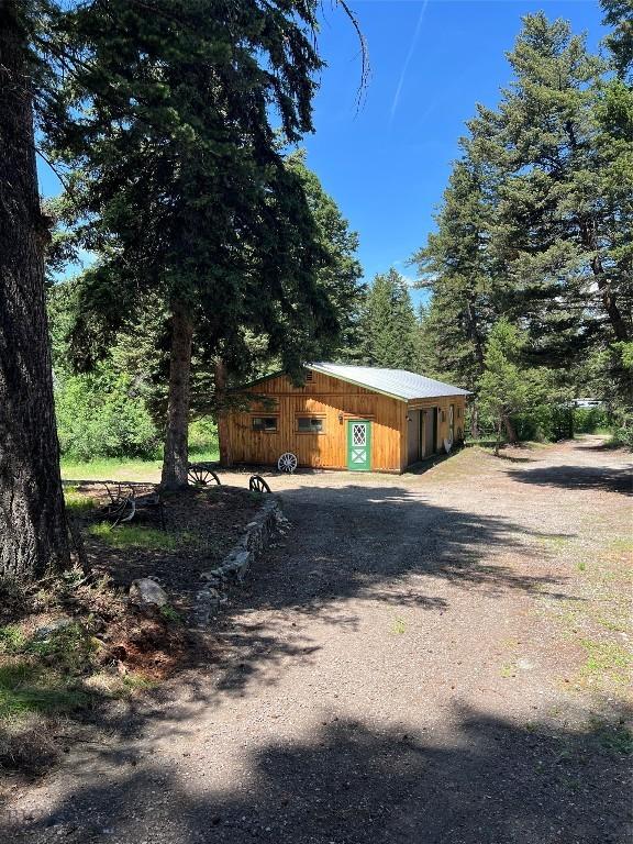 124 Deep Creek Rd, Livingston, MT 59047 - view of side of home featuring an outbuilding, a garage, and dirt driveway