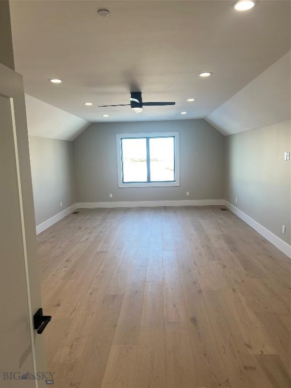 bonus room featuring vaulted ceiling, ceiling fan, and light hardwood / wood-style flooring