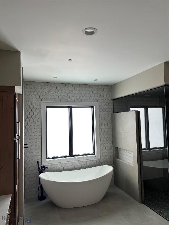 bathroom with tile patterned flooring and a bathtub