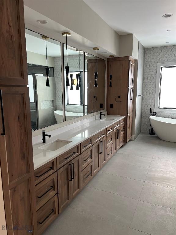 bathroom featuring vanity and a washtub