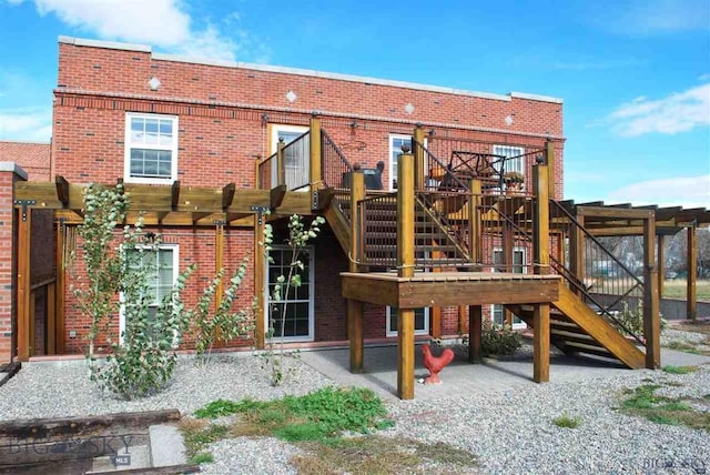 view of jungle gym featuring stairs, a deck, and a patio area