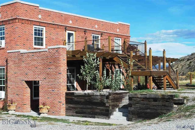 exterior space featuring stairway and brick siding