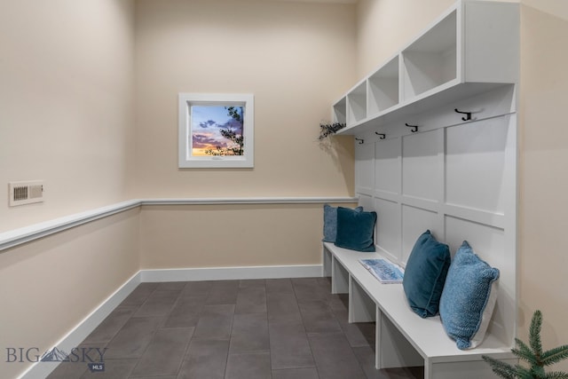 mudroom featuring dark tile patterned flooring