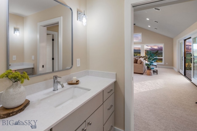 bathroom with vanity and vaulted ceiling