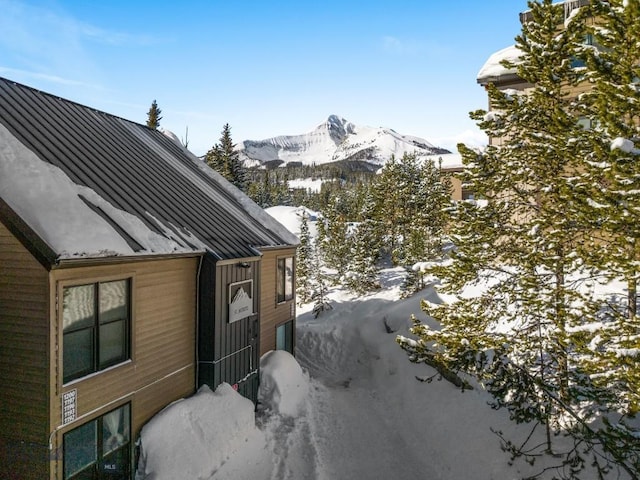 snow covered property featuring a mountain view