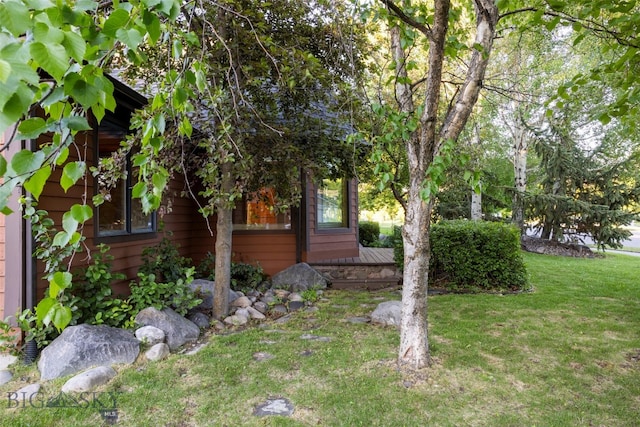 view of side of home featuring a lawn