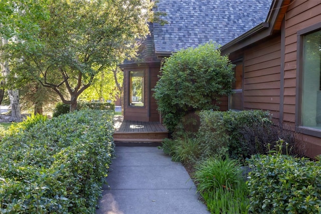 view of side of property featuring a wooden deck