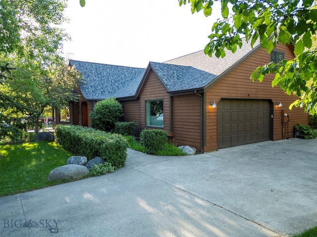 log cabin with a garage and a front lawn