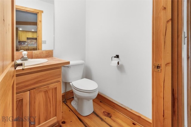 3127 Augusta Dr, Bozeman, MT 59715 - half bathroom with toilet, tasteful backsplash, vanity, and baseboards