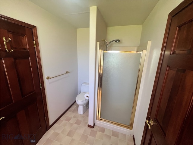 bathroom featuring an enclosed shower, tile patterned flooring, and toilet