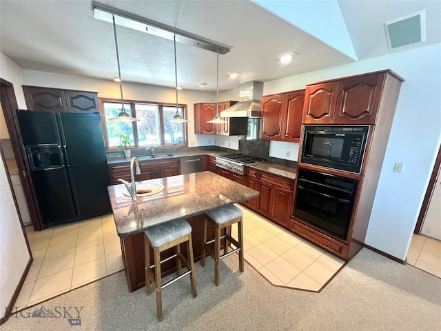 kitchen with black appliances, wall chimney exhaust hood, sink, a kitchen island, and light tile patterned floors