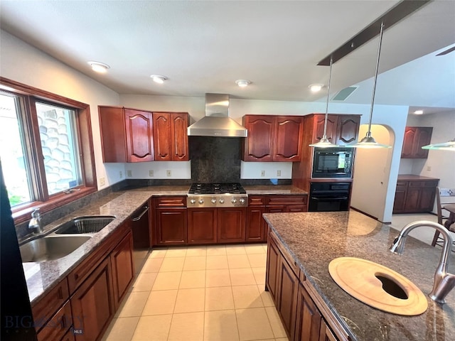 kitchen featuring light tile patterned floors, wall chimney range hood, black appliances, decorative light fixtures, and sink