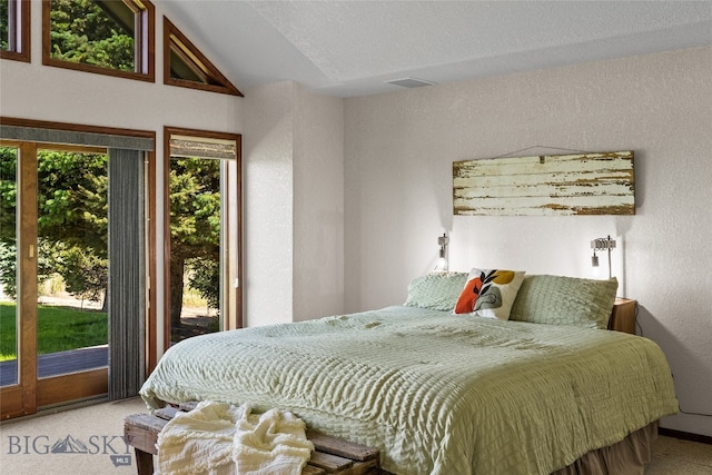 carpeted bedroom with access to exterior, a textured ceiling, and vaulted ceiling