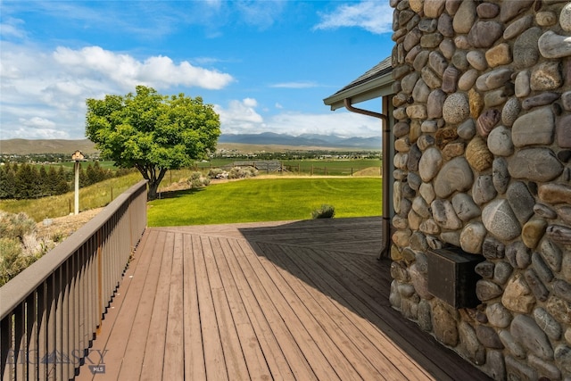 wooden deck with a lawn