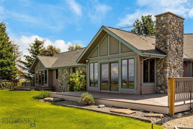 rear view of property featuring a yard and a wooden deck