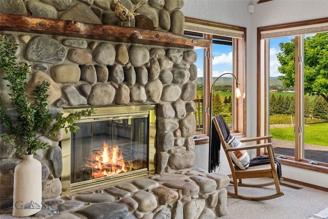 interior space with carpet floors and a fireplace