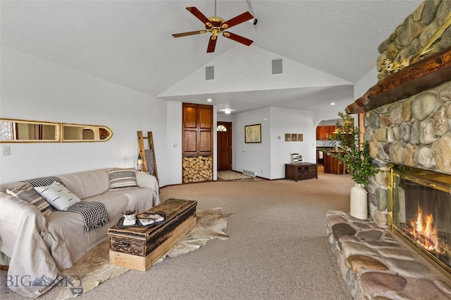 living room featuring a fireplace, carpet, high vaulted ceiling, and ceiling fan