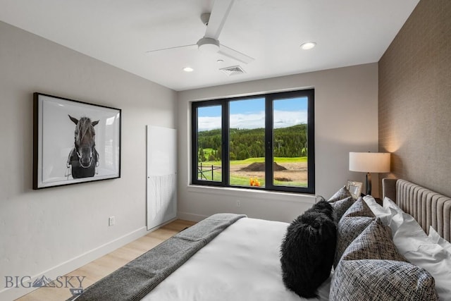 bedroom featuring light wood-type flooring and ceiling fan