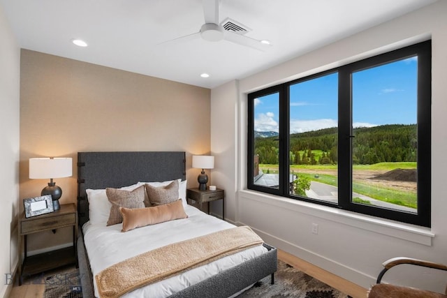 bedroom with ceiling fan and hardwood / wood-style flooring