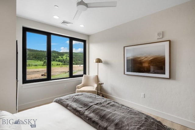 bedroom with hardwood / wood-style flooring and ceiling fan