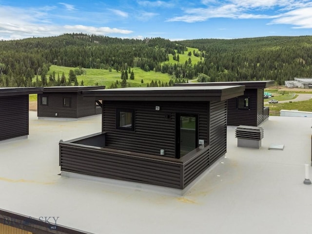 211 Town Center Ave Unit 3G, Big Sky, MT 59716 - view of patio featuring a forest view
