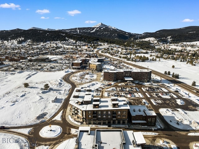 snowy aerial view featuring a mountain view