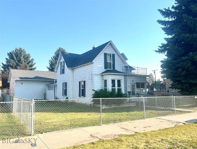 view of front of property featuring a front lawn and a balcony