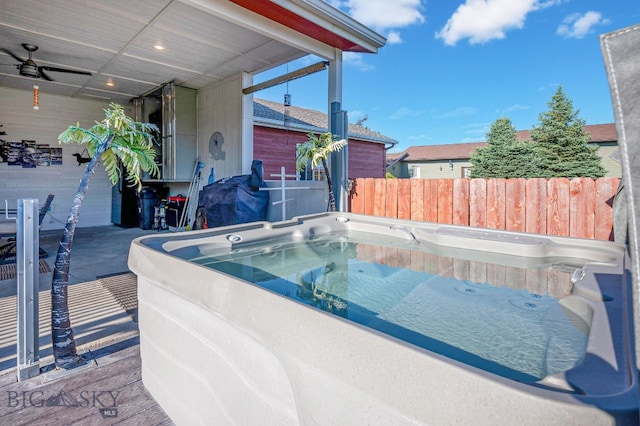 view of swimming pool with a hot tub and ceiling fan