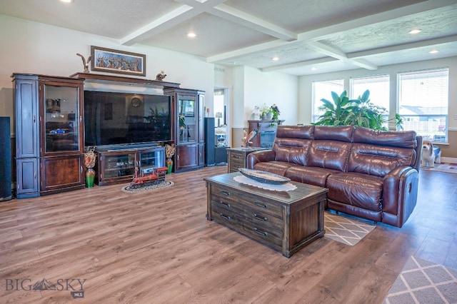 living room featuring coffered ceiling, wood-type flooring, and beamed ceiling