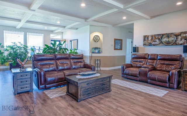 living room featuring beamed ceiling, coffered ceiling, and light wood-type flooring