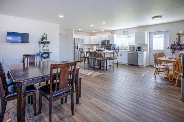 dining area with wood-type flooring and sink