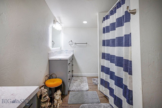 bathroom featuring vanity, curtained shower, and hardwood / wood-style floors