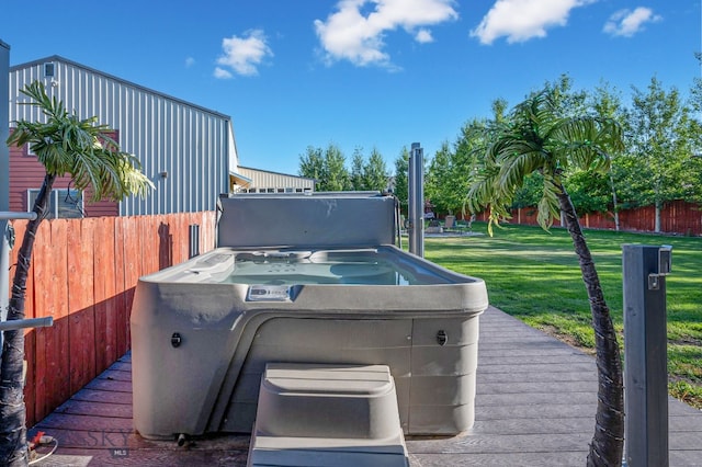 exterior space with a hot tub and a lawn