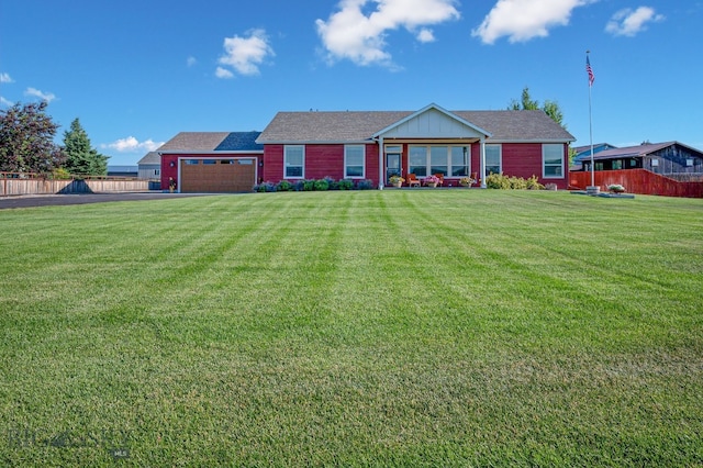 view of front of property featuring a garage and a front yard