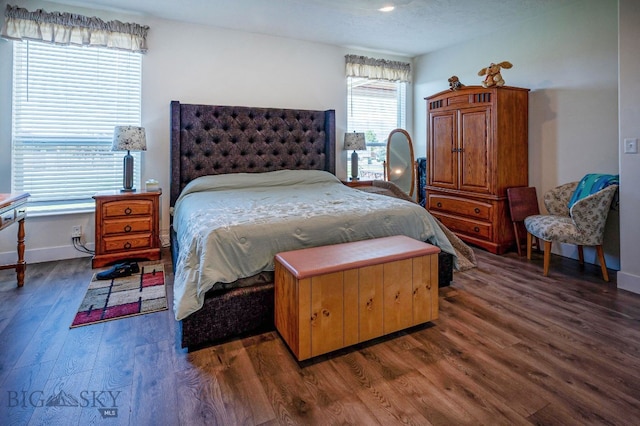 bedroom with dark wood-type flooring