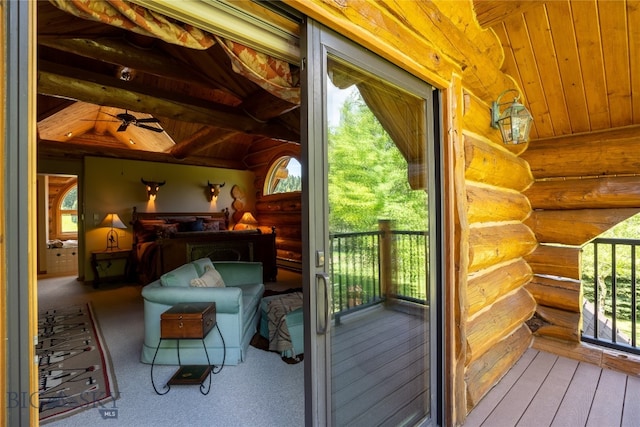 interior space featuring vaulted ceiling, wooden ceiling, log walls, and a healthy amount of sunlight