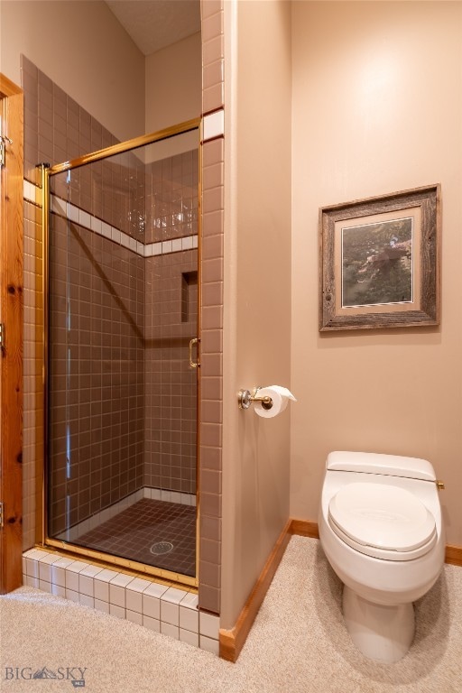 bathroom with toilet and an enclosed shower