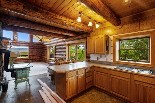 kitchen with beamed ceiling, rail lighting, log walls, and wood ceiling