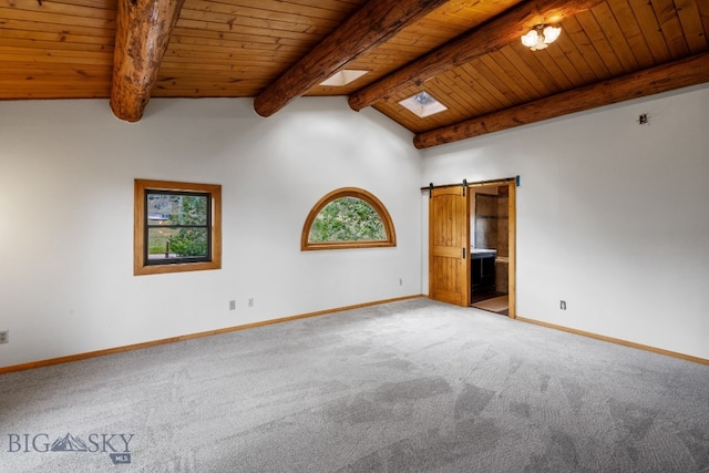 carpeted empty room featuring wood ceiling, a barn door, and vaulted ceiling with beams