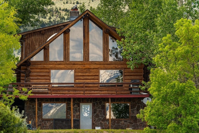 view of side of home featuring a balcony