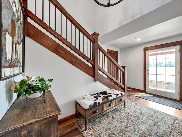 staircase with dark hardwood / wood-style flooring