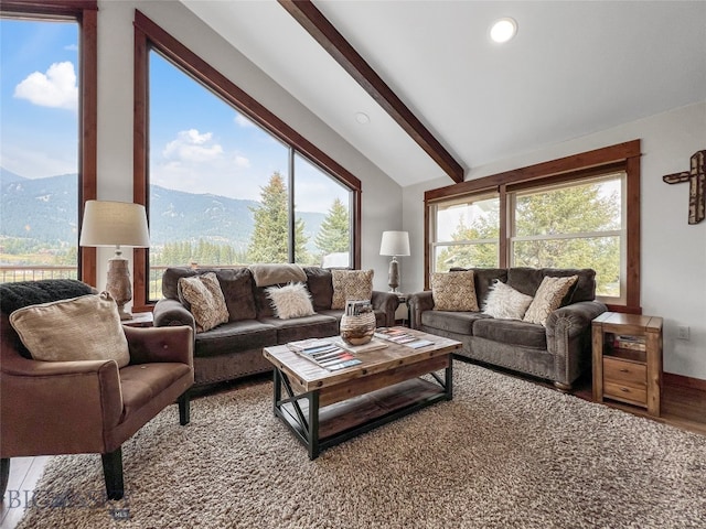 living room with a mountain view, vaulted ceiling with beams, and hardwood / wood-style floors