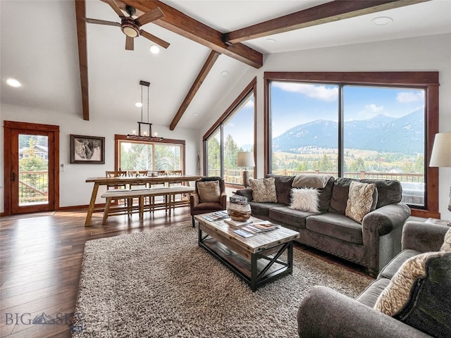 living room featuring dark hardwood / wood-style floors, lofted ceiling with beams, and plenty of natural light