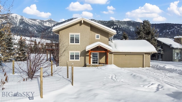 front of property featuring a garage and a mountain view